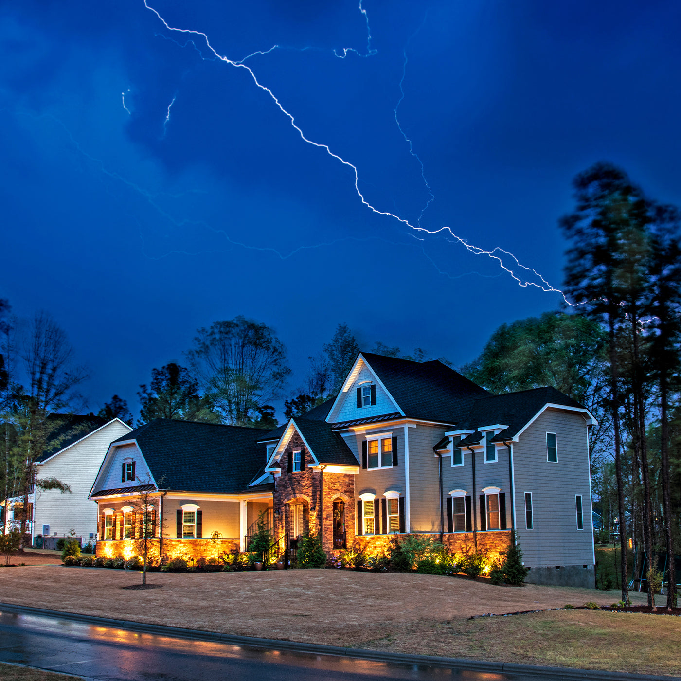 house-with-lights-on-during-lightning-storm
